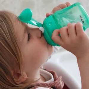 Child drinking from the Britton green non-spill soft-spout cup