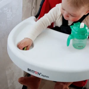 Britton green non-spill cup on a high-chair tray