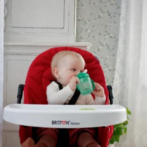 Baby drinking from the Britton green non-spill cup