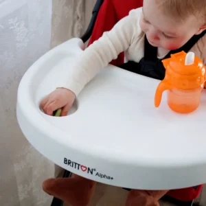 Britton orange non-spill cup on a high-chair tray