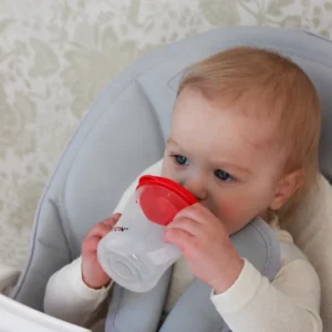 Baby drinking from the Britton First Cup 200 ml red