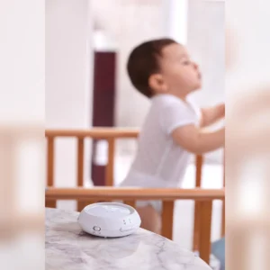 Bebcare Hear baby unit beside a crib – portrait view