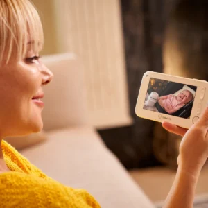 Parent using the Bebcare Motion baby monitor parent unit